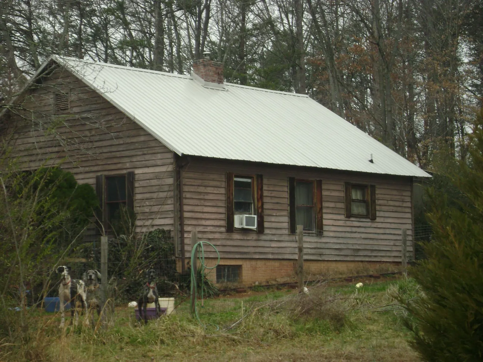 White metal roof on an old wood sided farmhouse, from a Metal Roof Installation job in Mc Louth